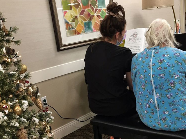 team member playing piano at christmas