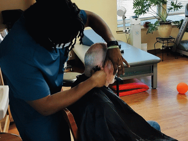 Therapist cutting patient's hair