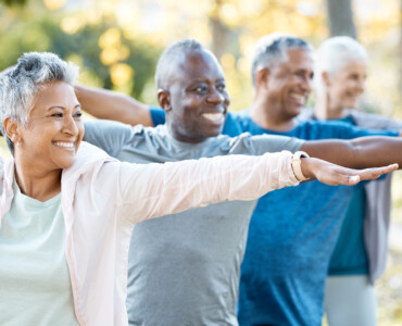 Stretching, yoga and senior people in park for muscle health, workout and training with retirement .